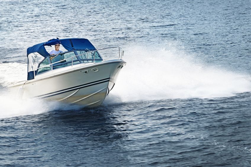 21536205 man piloting motorboat on lake in georgian bay, ontario, canada.